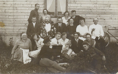 group of people on ground around record player