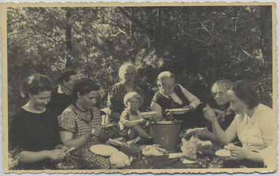 People eating meal in forest